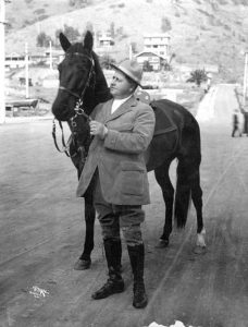 William Wrigley, Jr. holding a horse, c. 1919