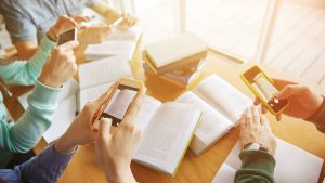 people taking pictures of pages inside of books