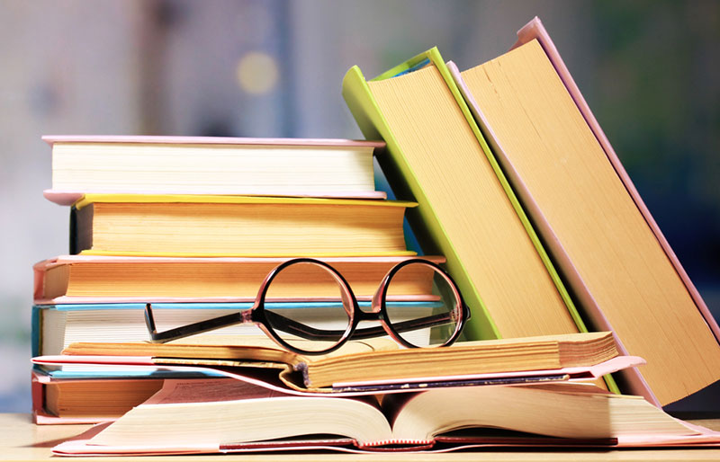 Glasses resting on books