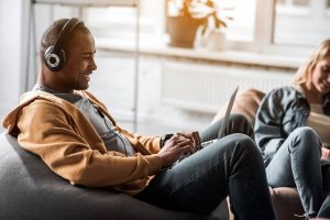 Male music lover typing on computer