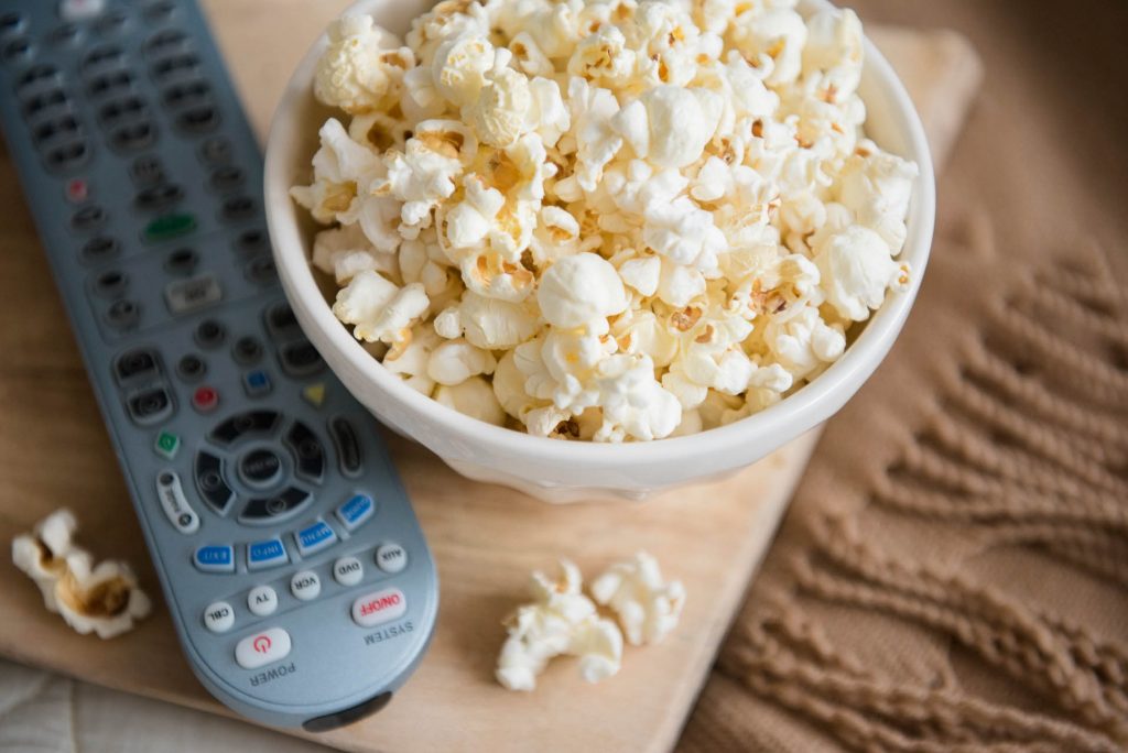 Bowl of popcorn and remote control