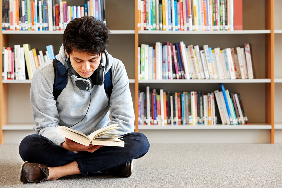 Teen boy reading a book