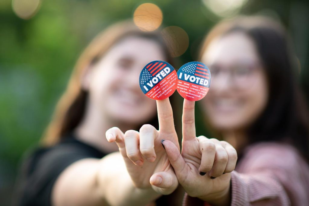 Women showing I Voted stickers