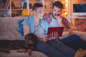 young gay couple looking at tablet