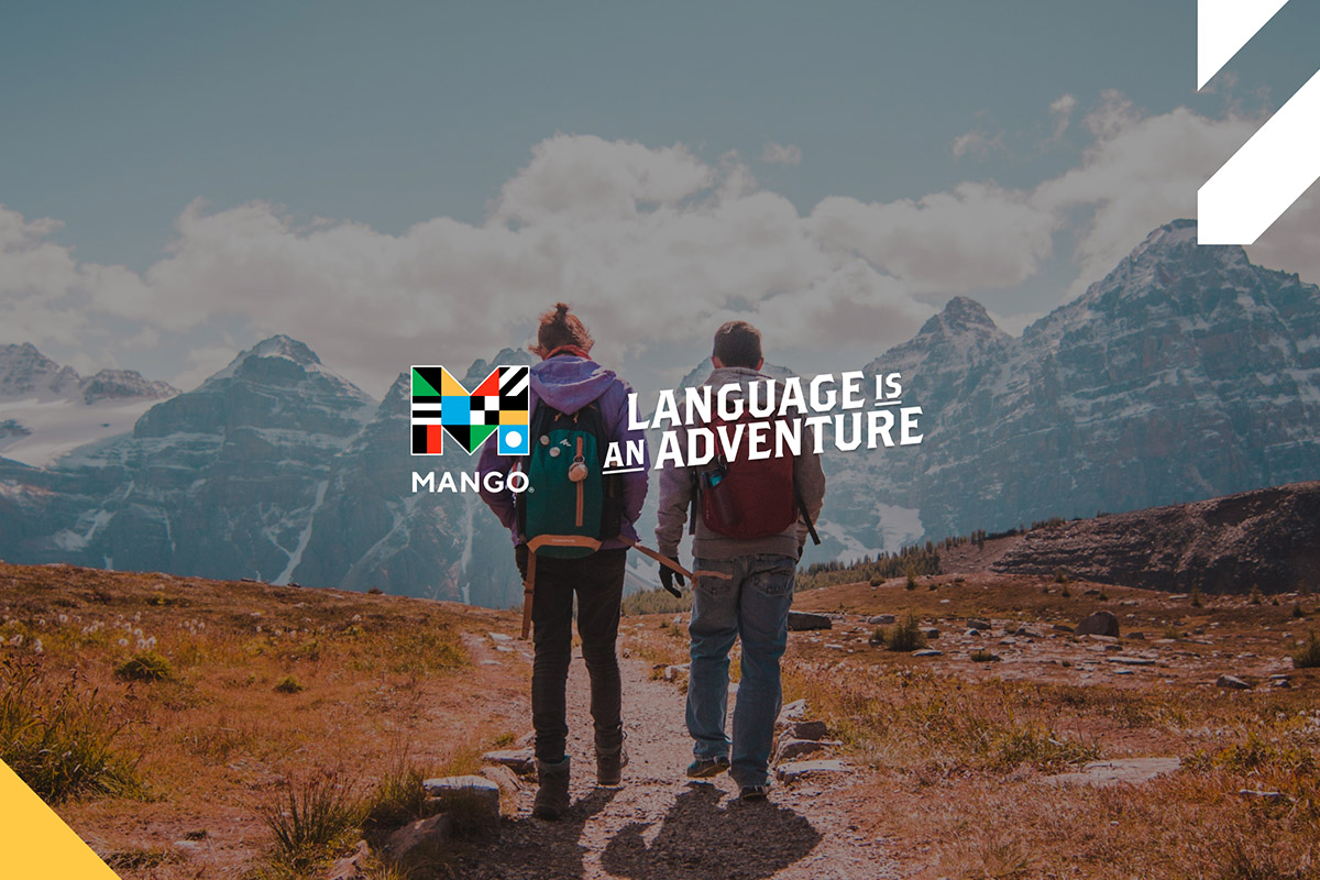 Men looking at mountain peaks with MangoLanguages logo
