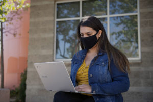 woman using free WiFi outside an LA County Library location