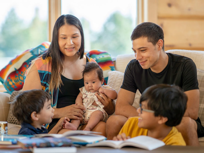 Native American family reading together