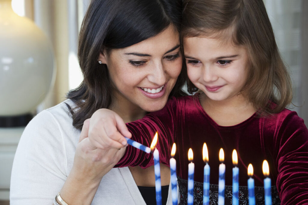 woman and child lighting candles