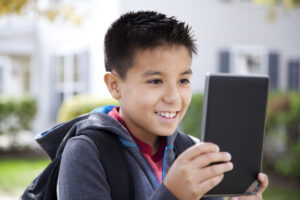 Young student reading a digital tablet