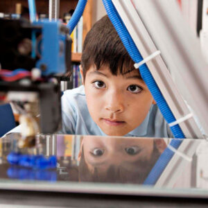 Boy looking at 3-D Printer