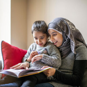 Muslim woman reading to a child