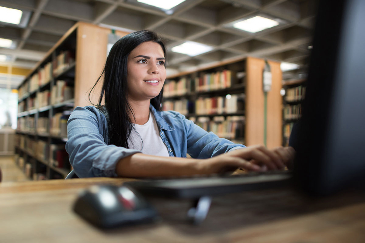 woman using a computer at the library