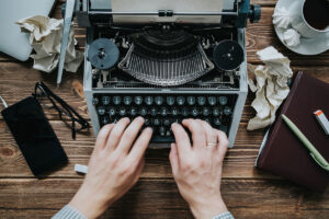hands on a manual typewriter