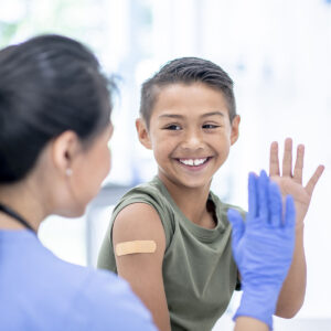 boy and healthcare professional at vaccine clinic