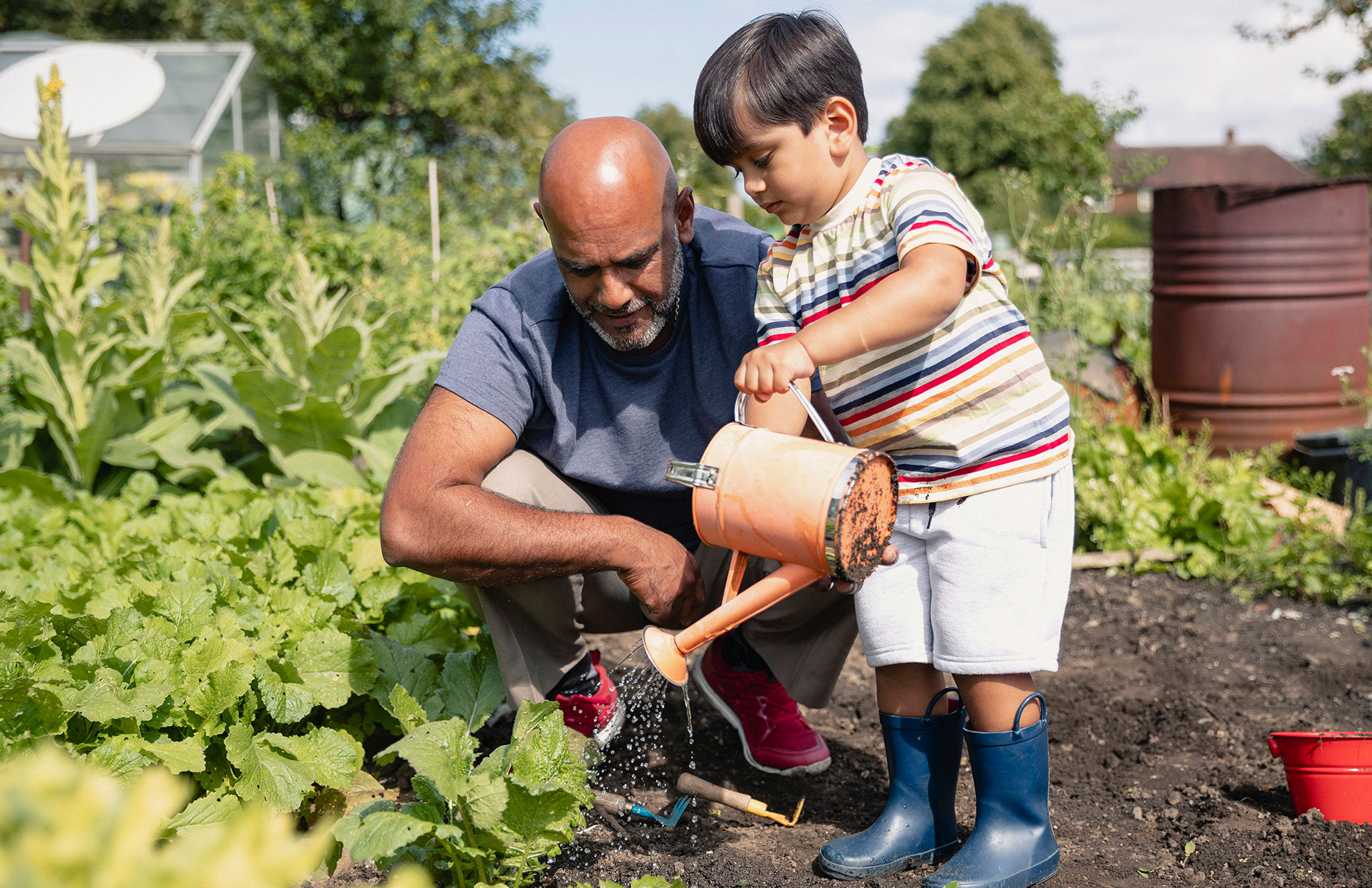 Adult and child gardening together