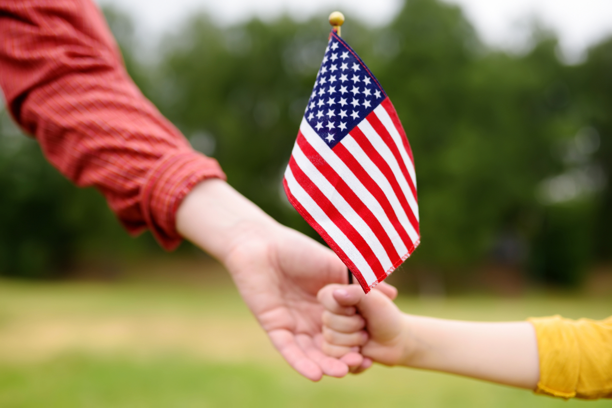 hands holding a small American flag