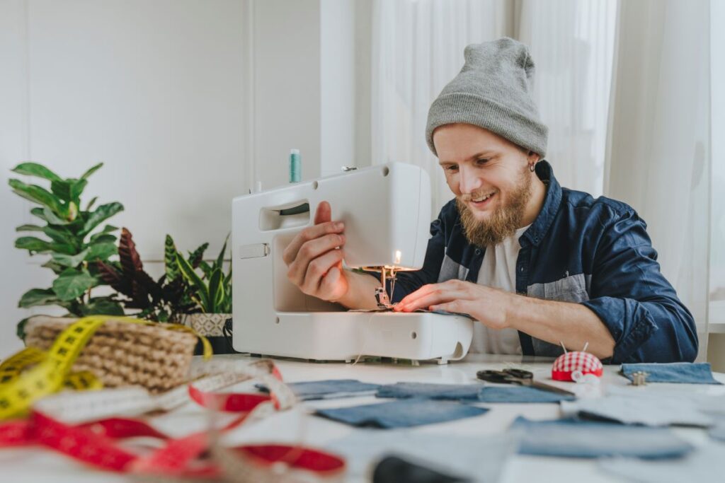 young man using a sewing machine