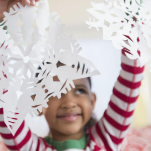 Child making paper snowflakes