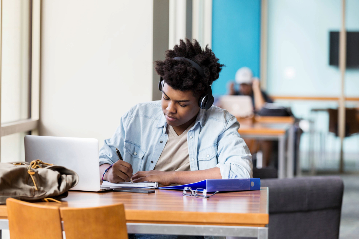 young man using free Wi-Fi at the library