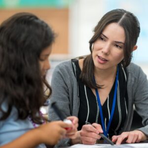 female adult tutoring a school age girl