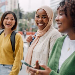 three women, one in a head scarf