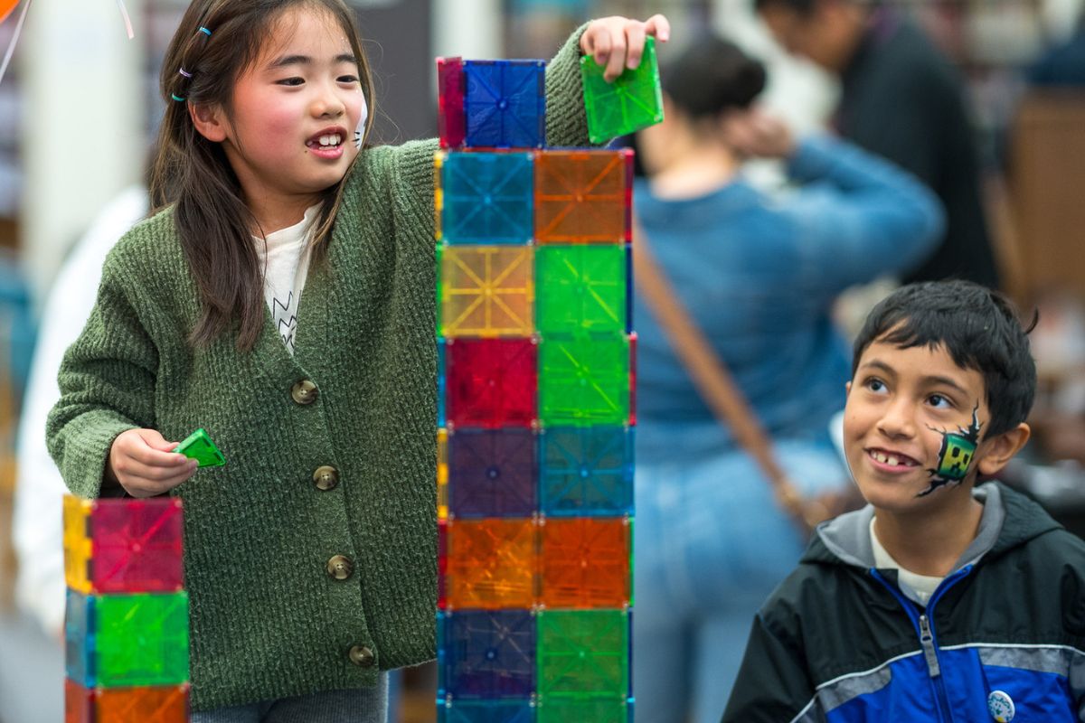 happy kids building a tower at a library event