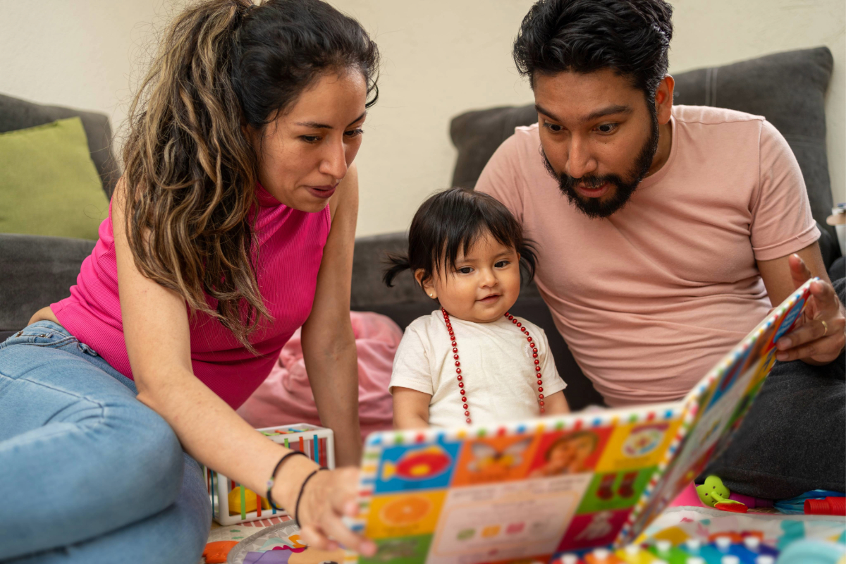 parents reading to small child