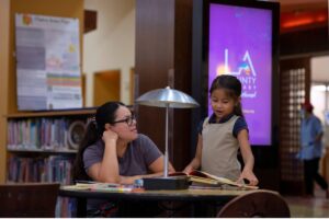 adult and child staying cool at LA County Library
