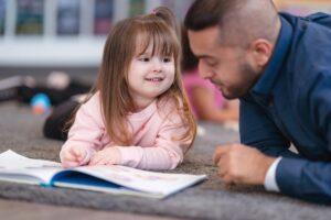 daughter and father reading a picture book