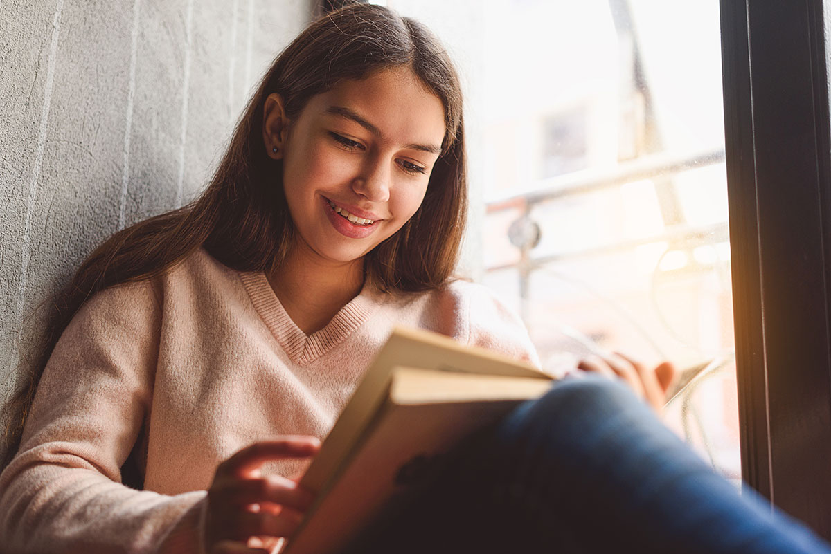 teen reading a book