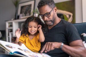 father and child reading a picture book