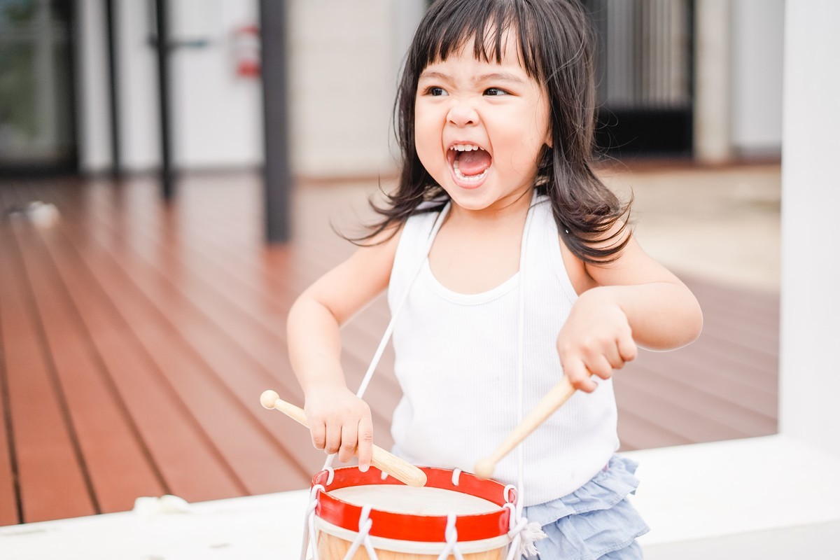 early learner playing a drum