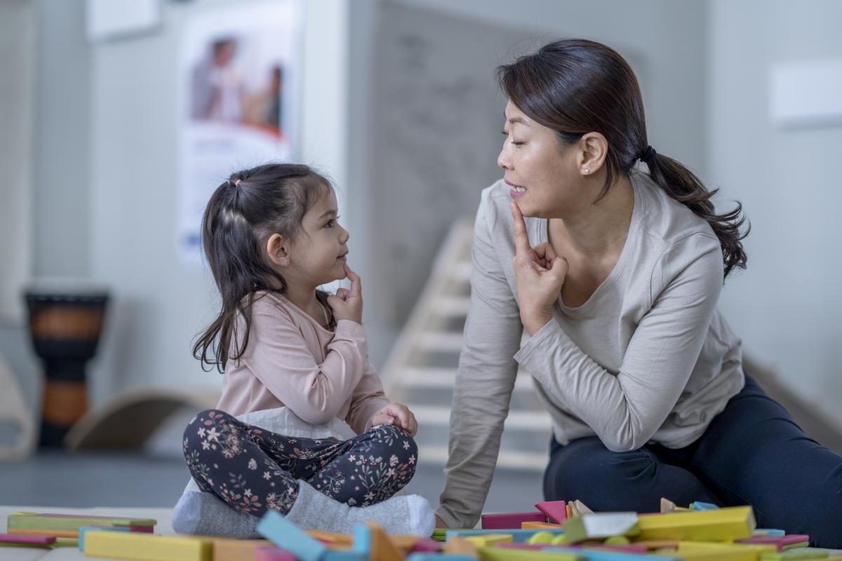 mother and child touching their chins