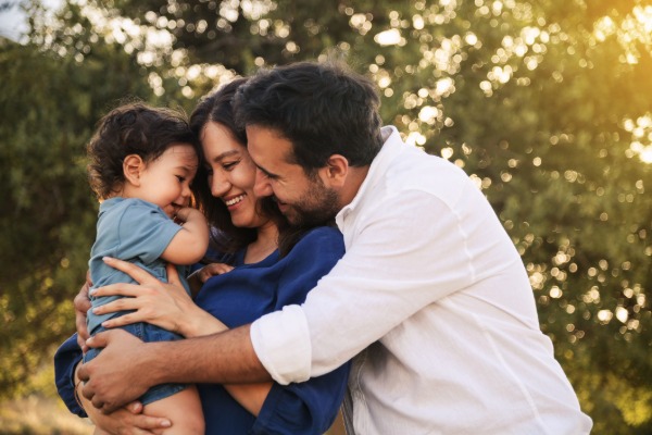 parents hugging a child