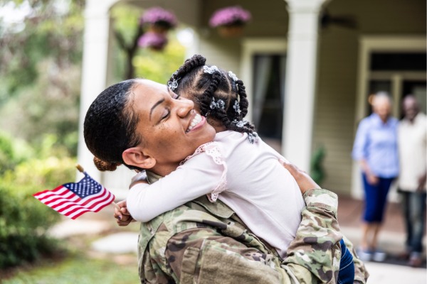 veteran hugging a small child