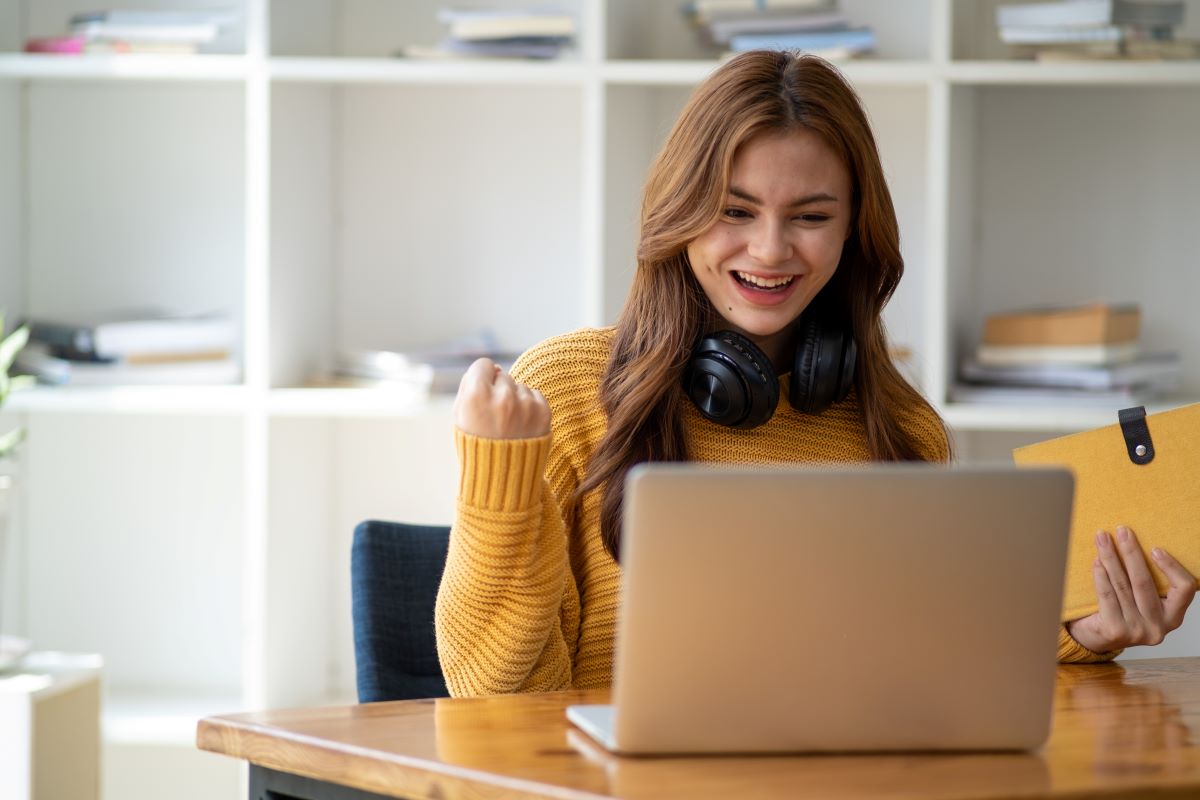 happy learner using a laptop