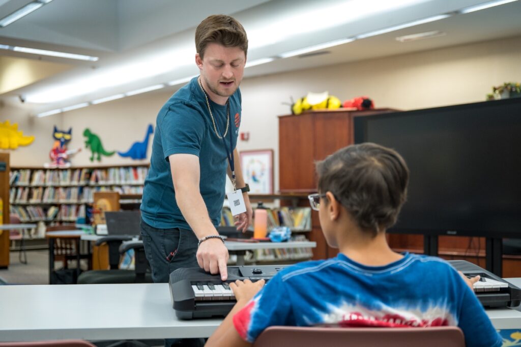 teacher and student at Music Stars program