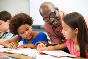 adult helping students with homework