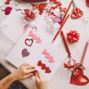 child doing Valentines day crafts