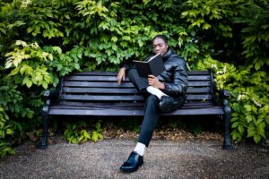 Man reading on a park bench