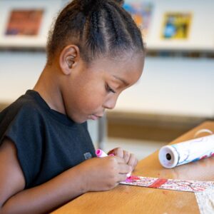 little girl coloring a bookmark