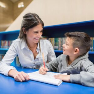 Teacher with a student at the library