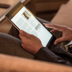 person reading a newspaper on a tablet