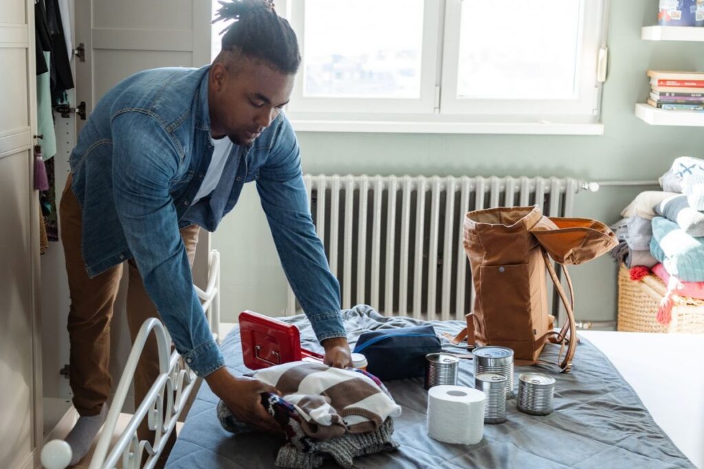 man putting together a disaster kit
